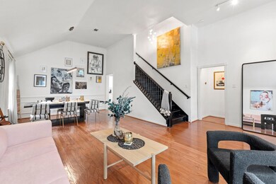 Living room with high vaulted ceiling, rail lighti