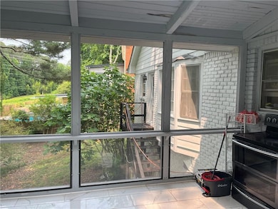 Sunroom with healthy amount of natural light and a wood stove