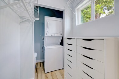 The closet includes a stacked washer and dryer. No going to the garage to do laundry!