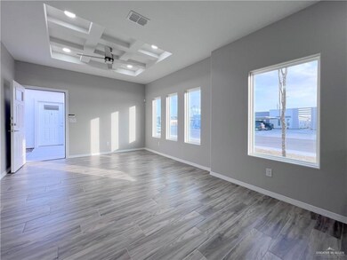 Unfurnished room with coffered ceiling, a ceiling fan, recessed lighting, wood finished floors, and baseboards