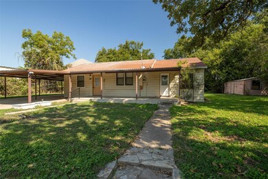 View of front facade featuring a porch, a carport,