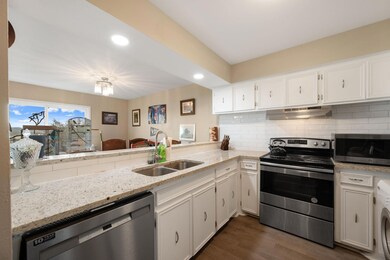 Kitchen with stainless steel appliances, white ca
