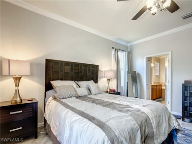 Bedroom with crown molding, ensuite bathroom, and