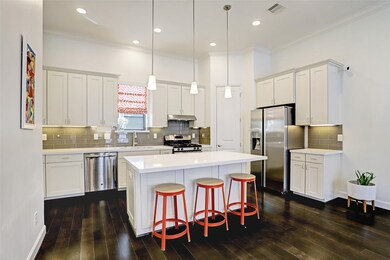 The crown molding, white cabinetry in this kitchen