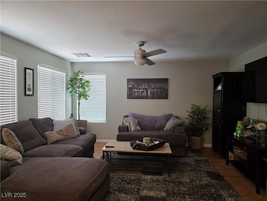 Family room featuring ceiling fan, wood blinds and