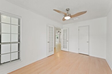 Bright room with light wood flooring, white walls,