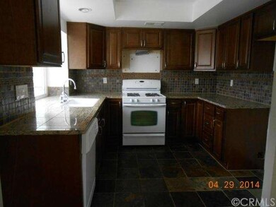Kitchen w/Wood Cabinets, Stone Floors & Granite Co