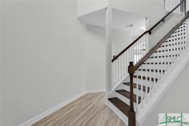 ENTRANCE WITH WOOD STAIRCASE