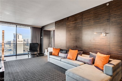 Living area featuring a wall of windows, wood fini