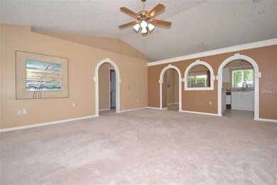 Greatroom with plant shelves & archway detail!  Neutral decor!