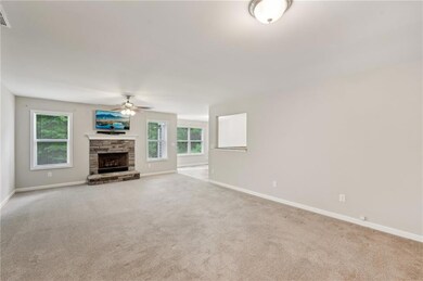 Unfurnished living room featuring a fireplace, a w