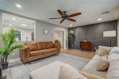 Living room featuring light wood-type flooring and ceiling fan