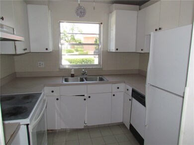 Compact but well laid out kitchen offers a window
