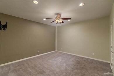 Carpeted spare room with ceiling fan