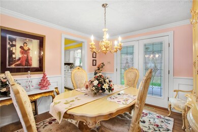 FROM THE FORMAL DINING ROOM FRENCH DOORS LEAD TO T