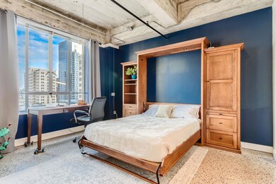 Bedroom with baseboards and a city view