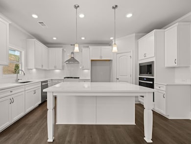 Westerly updated kitchen with a larbe quartz topped center island for bar seating