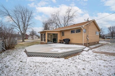 Snow covered property featuring a sunroom and a wo