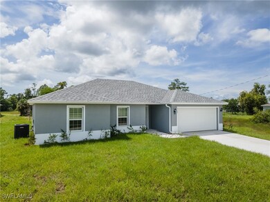 Ranch-style home with stucco siding, a garage, dri