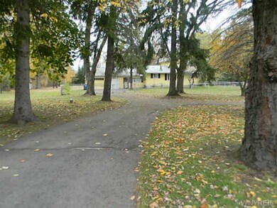 Exterior Front. Long, semi-circular driveway.  Vie