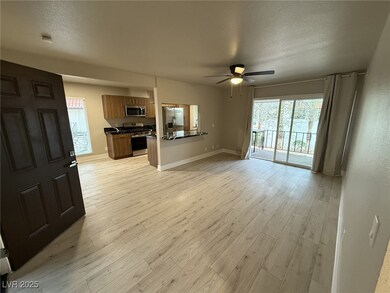 Unfurnished living room featuring ceiling fan, a t