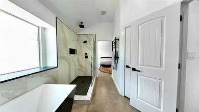Ensuite bathroom featuring a marble finish shower