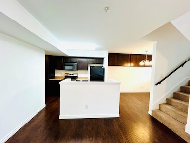 Kitchen with decorative light fixtures, dark wood 