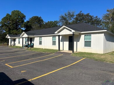 Ranch-style home featuring roof with shingles, board and batten siding, and uncovered parking
