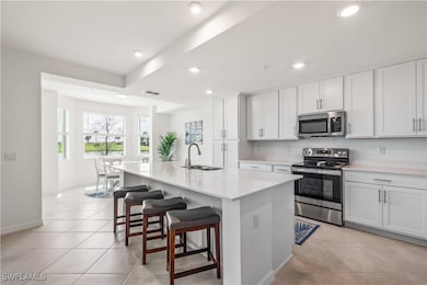 Kitchen with light tile patterned floors, applianc