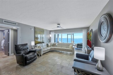 Living room with stone tile floors, baseboards, vi