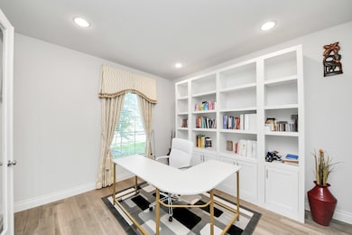 The office is located at the front of the home, wi
