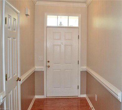 Front entrance to the house. Coat closet pictured on the left. Harwood floors here.