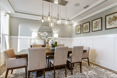Flexible space downstairs off the foyer entry. Dining room shown here. Option to convert to a study with glass French doors or a full bedroom and bathroom.