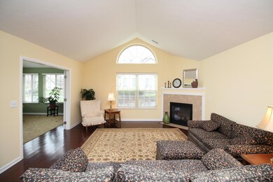 Great Room features gas fireplace, gleaming hard wood floors and vaulted ceilings!