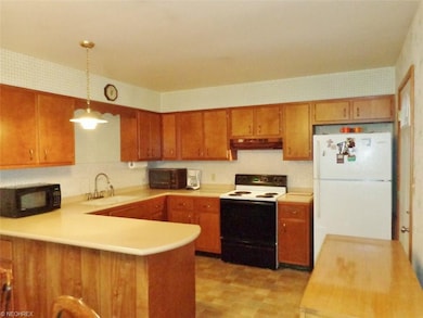 The spacious eat-in kitchen boasts corian counter-