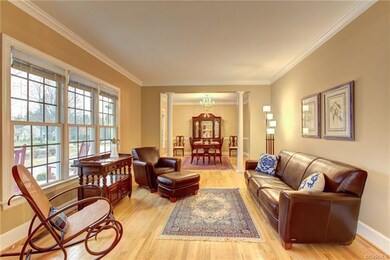 The Living Room with Hardwood Floors flows to the 