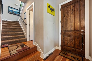 Entryway with stairway and wood finished floors