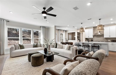 Gathering room featuring a ceiling fan, wood finished floors and LED lighting