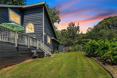 View of yard featuring a deck and stairs