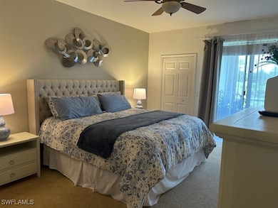 Carpeted bedroom with a closet and ceiling fan