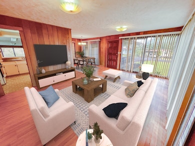 Living room looking towards dining area & kitchen, notice wrap around windows allowing lots of light (virtually staged).