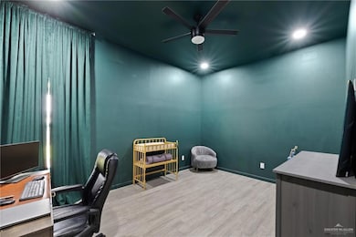 Home office featuring light wood finished floors, ceiling fan, and recessed lighting