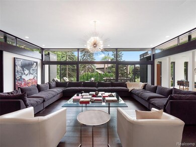 Living area featuring floor to ceiling windows, a chandelier, plenty of natural light, recessed lighting, and wood-type flooring