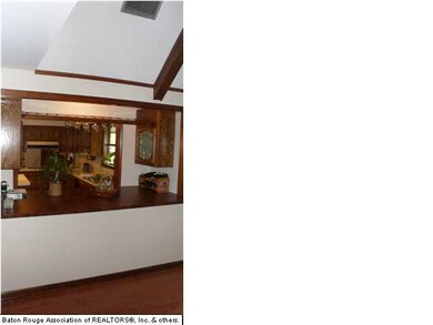 Den looking into the kitchen with bar area