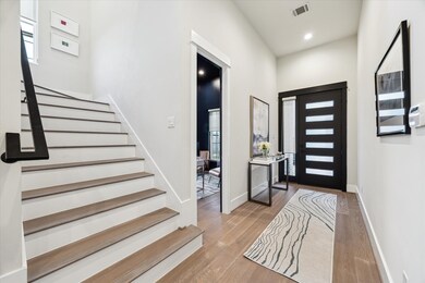 Elegant entry with high ceilings, a convenient stu