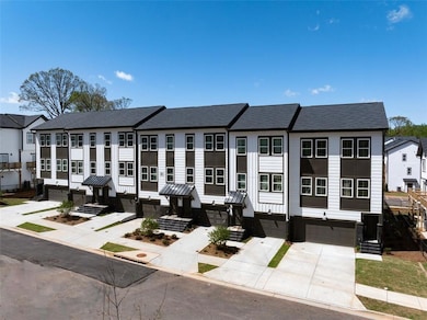 View of front of property featuring a shingled roof, an attached garage, a residential view, and concrete driveway