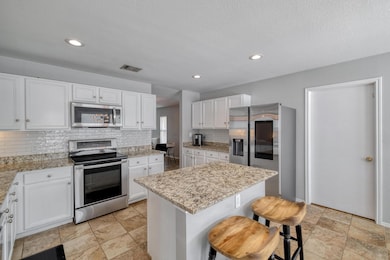Kitchen featuring stainless steel appliances, bac
