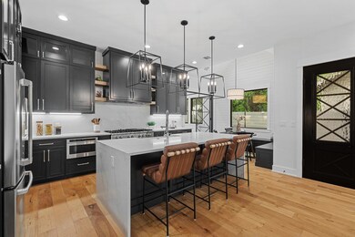 Kitchen with light wood-type flooring, dark cabin