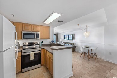 Kitchen with stainless steel appliances, a chandel