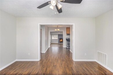 Empty room with dark wood finished floors, baseboa